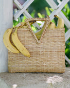 Veronica Beard Woven straw tote bag with triangular handles and a patterned fabric lining.