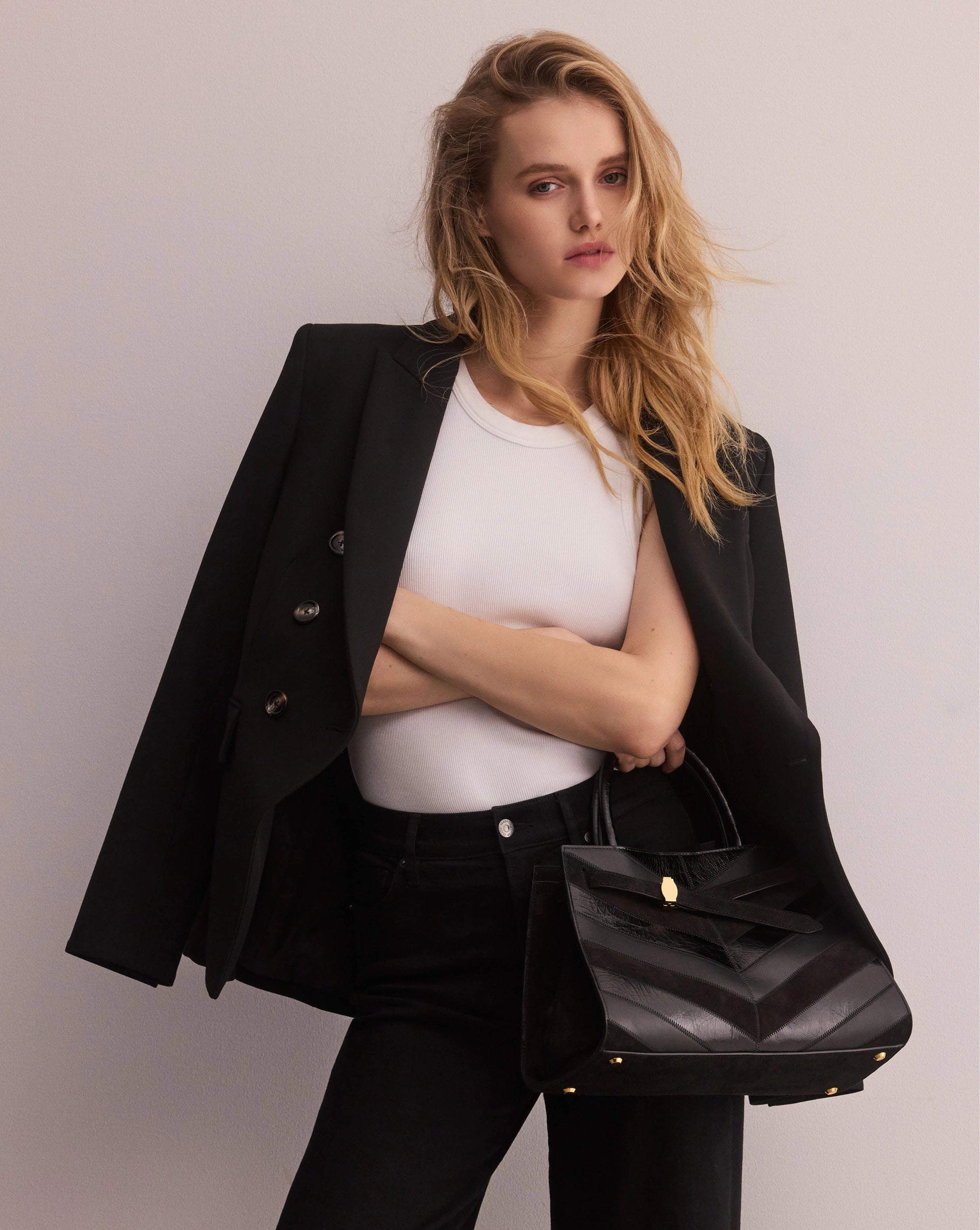 Veronica Beard Black leather handbag, chevron pattern, structured trapezoid silhouette.