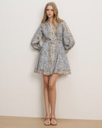 Veronica Beard Light blue floral print mini dress with long balloon sleeves, a belted waist, and white trim.