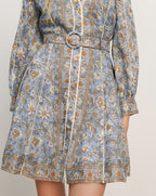 Veronica Beard Light blue floral print mini dress with a belted waist and long sleeves.
