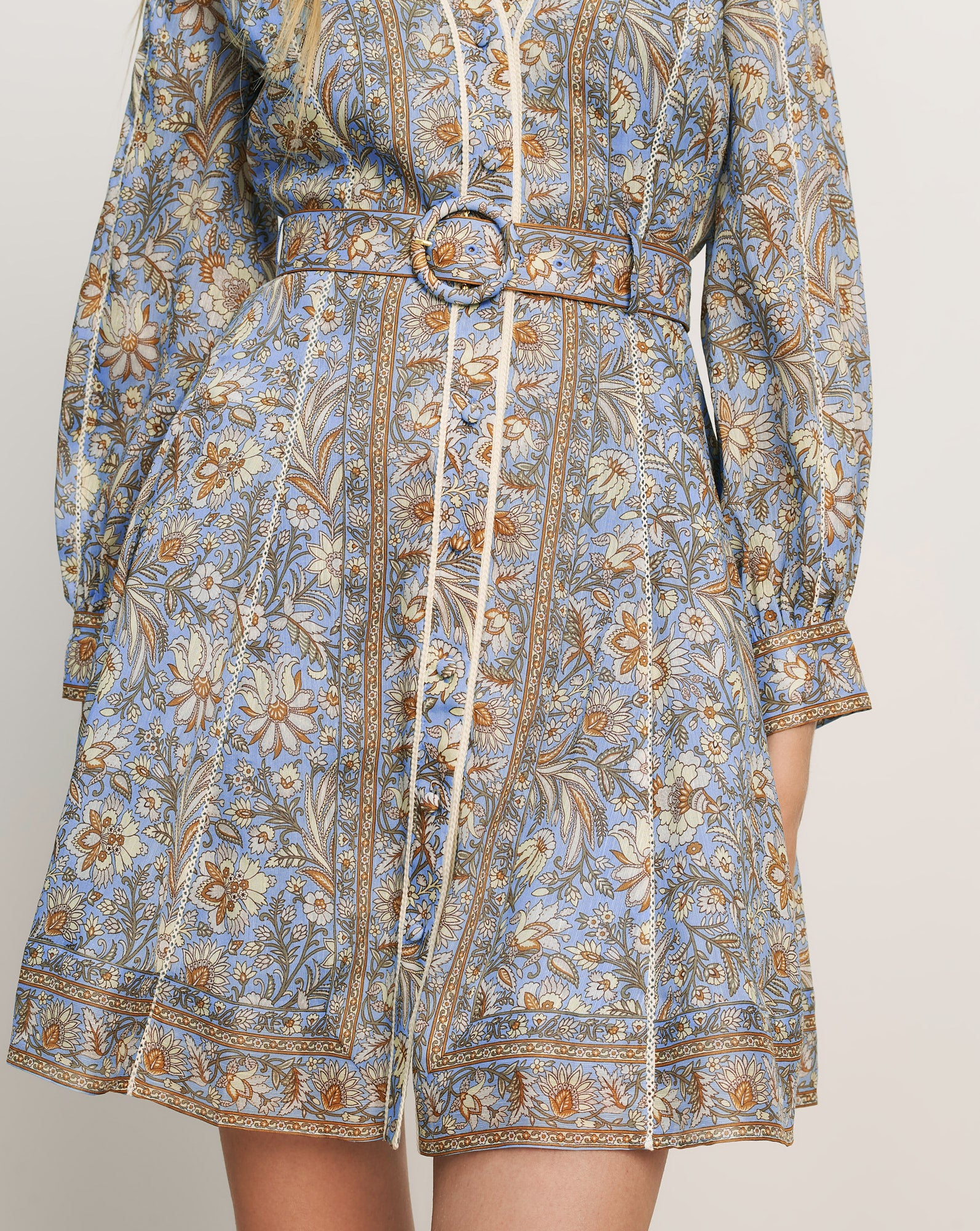 Veronica Beard Light blue floral print mini dress with a belted waist and long sleeves.