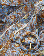 Veronica Beard Light blue floral print dress with a matching fabric belt and gold buckle.