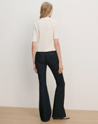 Veronica Beard Cream short-sleeve knit top and dark wash flared jeans.
