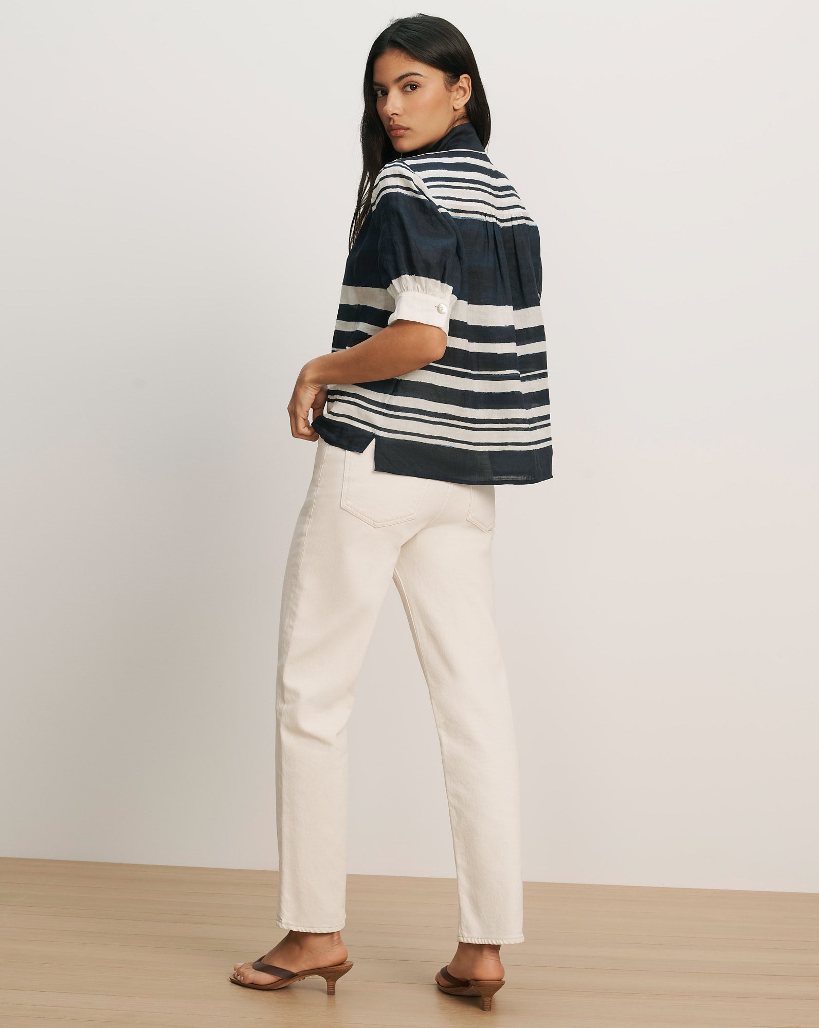 Veronica Beard Navy and white striped short-sleeve button-up shirt with white cuffs and off-white straight-leg pants.