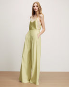 Veronica Beard Light green high-waisted wide-leg pleated trousers.