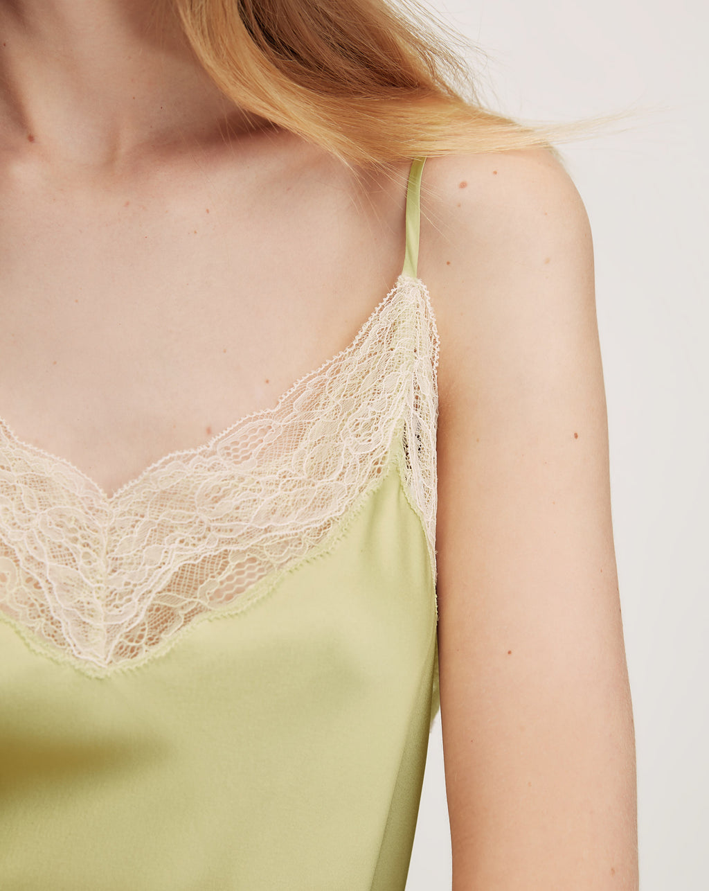 Veronica Beard Lime green satin camisole with lace trim and matching wide-leg pants.