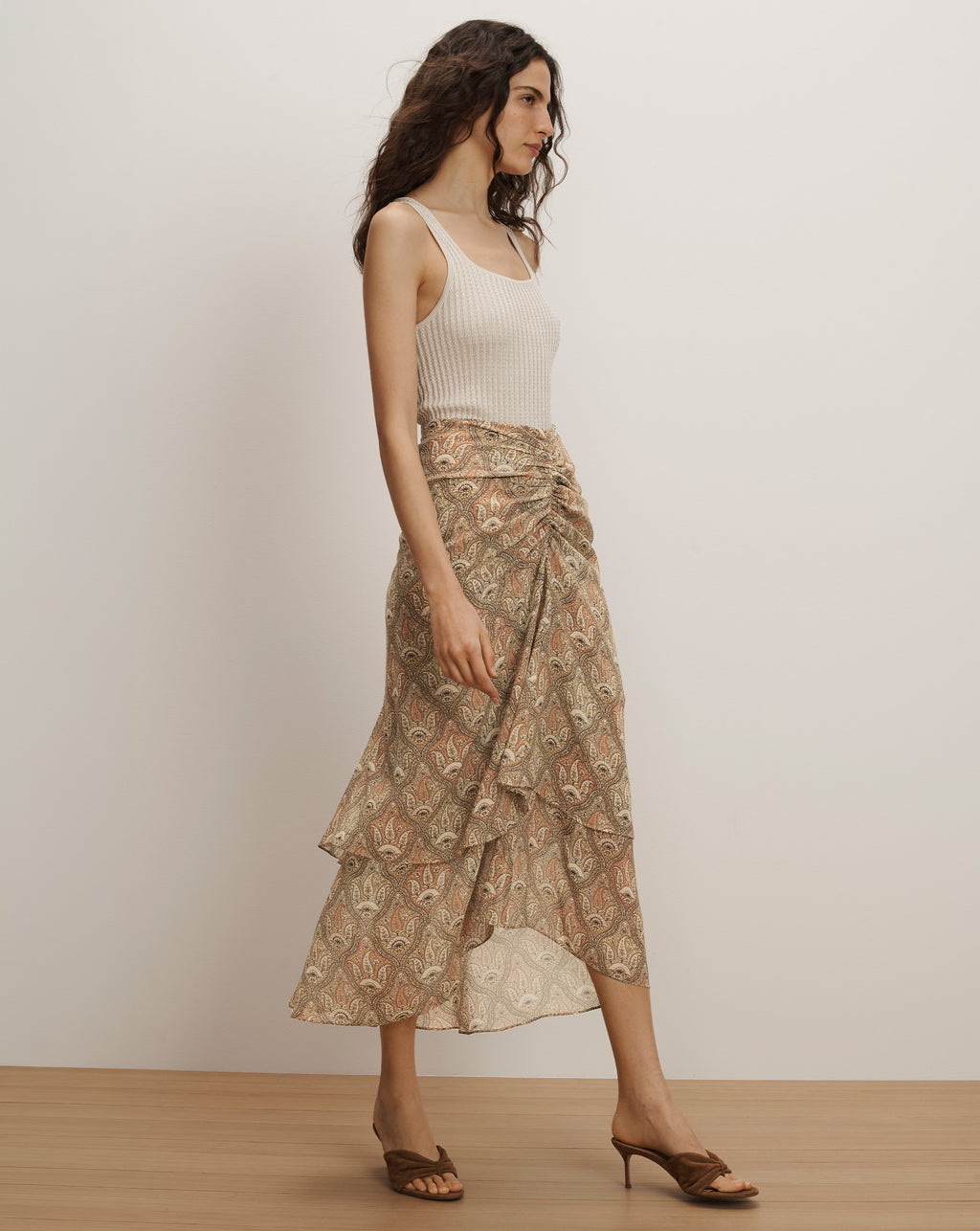 Veronica Beard Ribbed cream tank top and a beige paisley print midi skirt with a ruffled, asymmetrical hem.