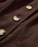 Veronica Beard Brown sleeveless button-front vest and black floral midi skirt.