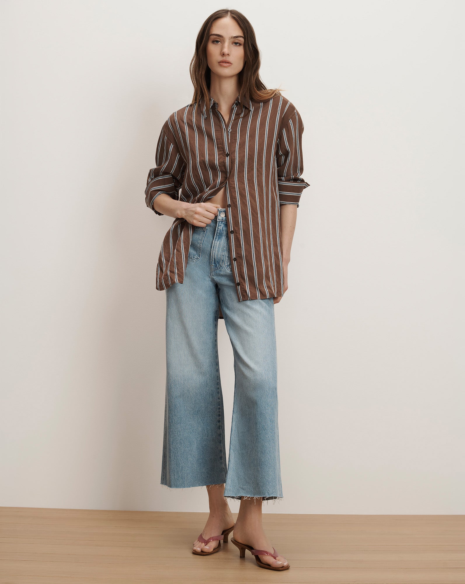 Veronica Beard striped button-up shirt and wide-leg denim jeans, paired with brown sandals.