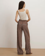 Veronica Beard Ribbed cream tank top and brown and white striped wide-leg pants.