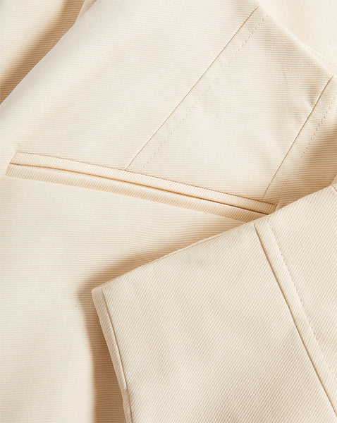 Veronica Beard Cream blazer with notched lapels and flap pockets.