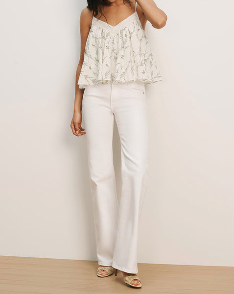 Veronica Beard White floral camisole and white wide-leg jeans.