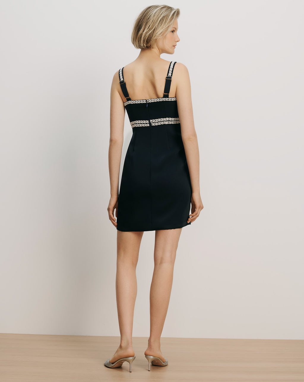 Veronica Beard Black mini dress with braided straps and waist trim.