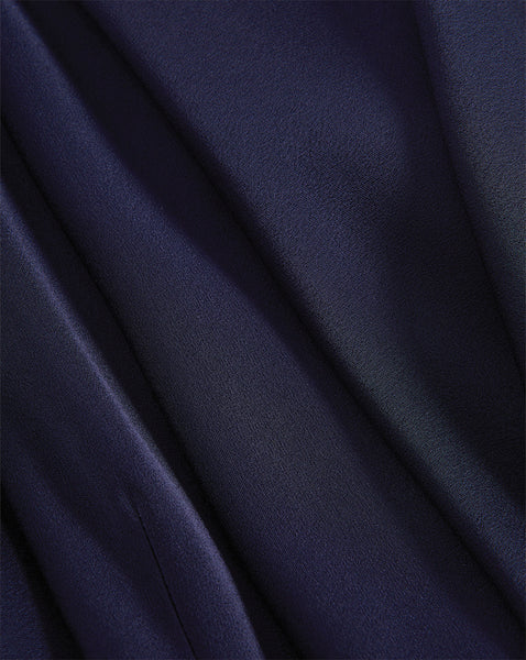 Veronica Beard Navy blue satin fabric with soft folds.