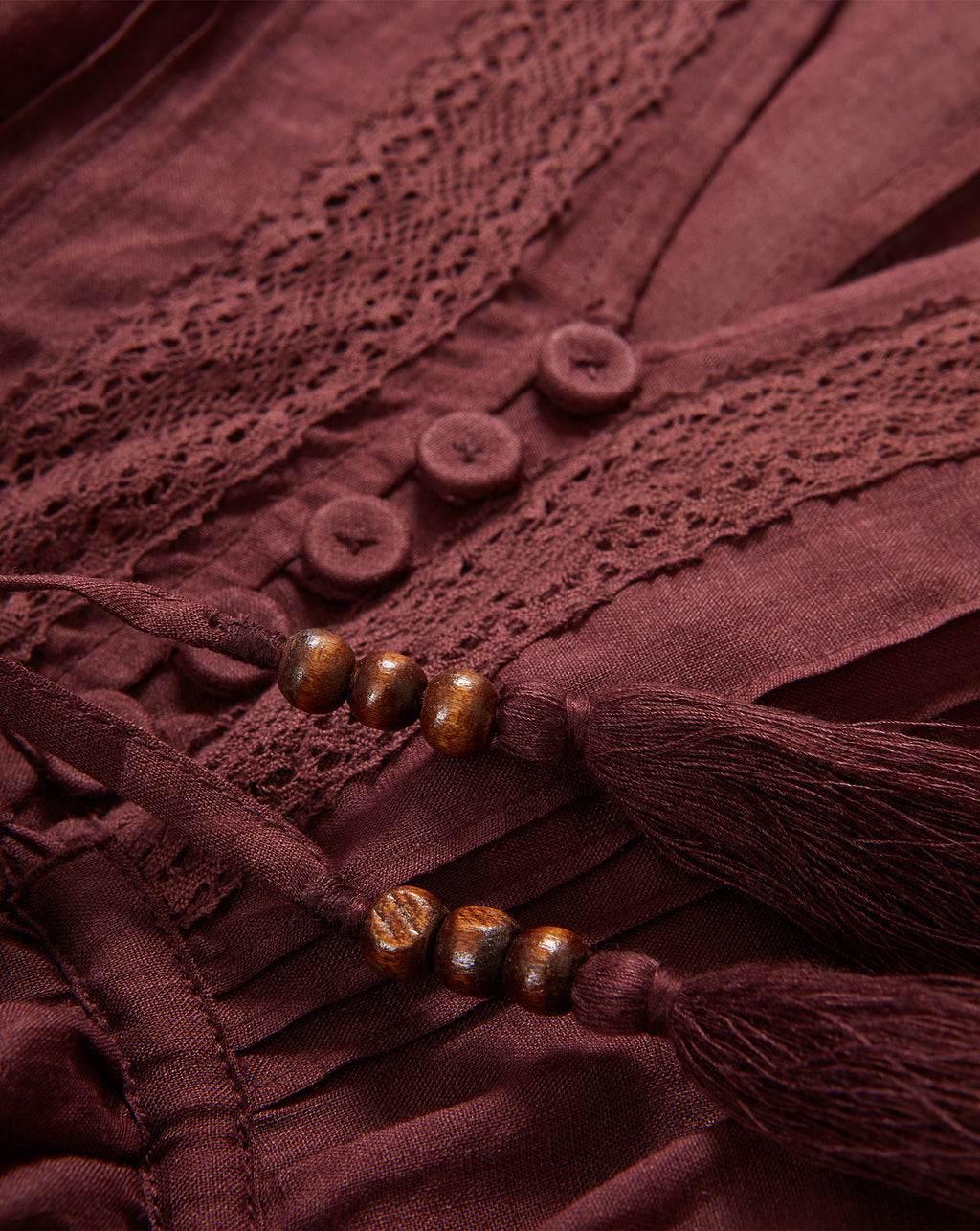 Veronica Beard Brown dress with lace trim, buttons, and beaded tassels.