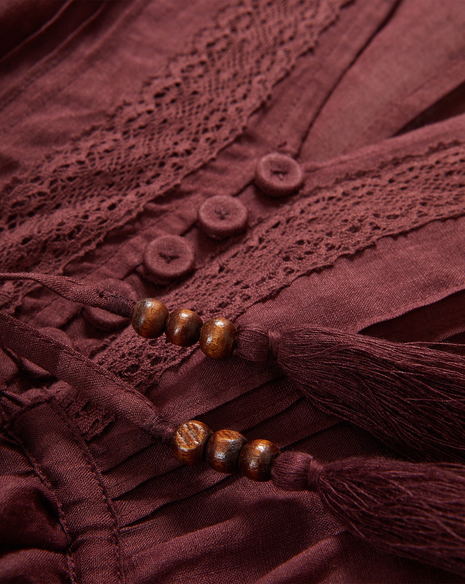 Veronica Beard Brown dress with lace trim, buttons, and beaded tassels.