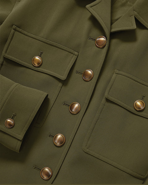 Veronica Beard Olive green jacket with brass buttons and flap pockets.