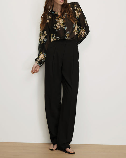 Veronica Beard Black floral sheer blouse and black wide-leg pants.