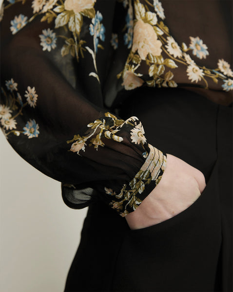 Veronica Beard Black floral chiffon blouse with smocked cuffs.