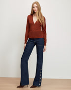Veronica Beard Brown knit sweater, dark wash flared jeans with buttons.