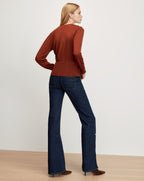 Veronica Beard Rust knit top, dark wash flared jeans.