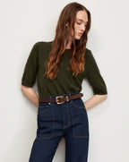Veronica Beard Olive green knit top, dark wash jeans, brown belt.