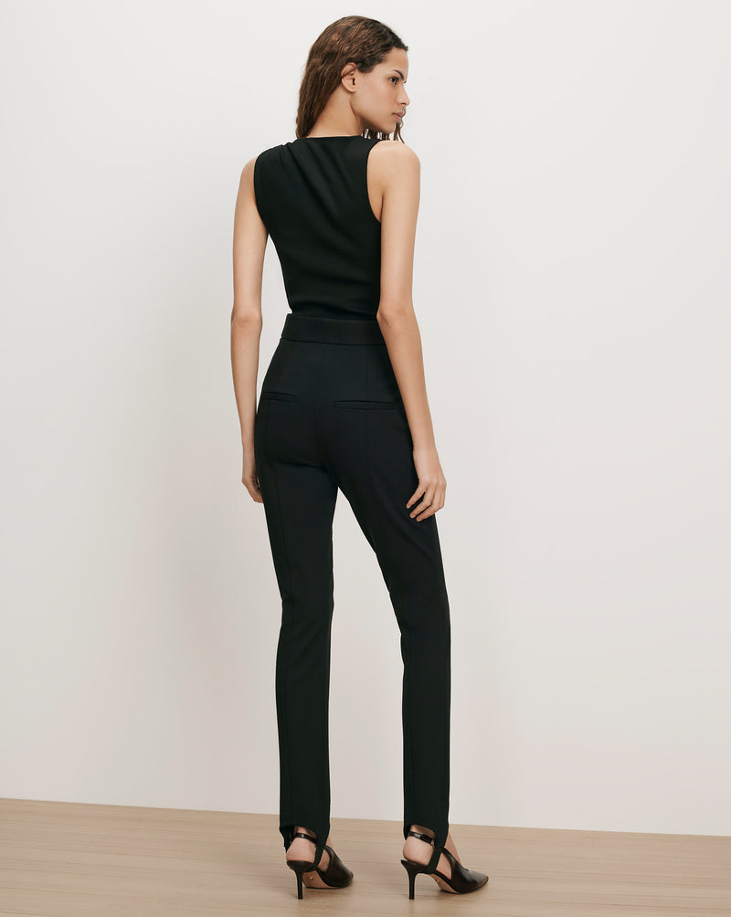 Veronica Beard Black sleeveless top and slim-fit pants with stirrups.