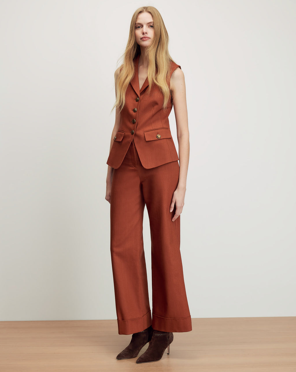 Veronica Beard Rust sleeveless vest and wide-leg pants suit.