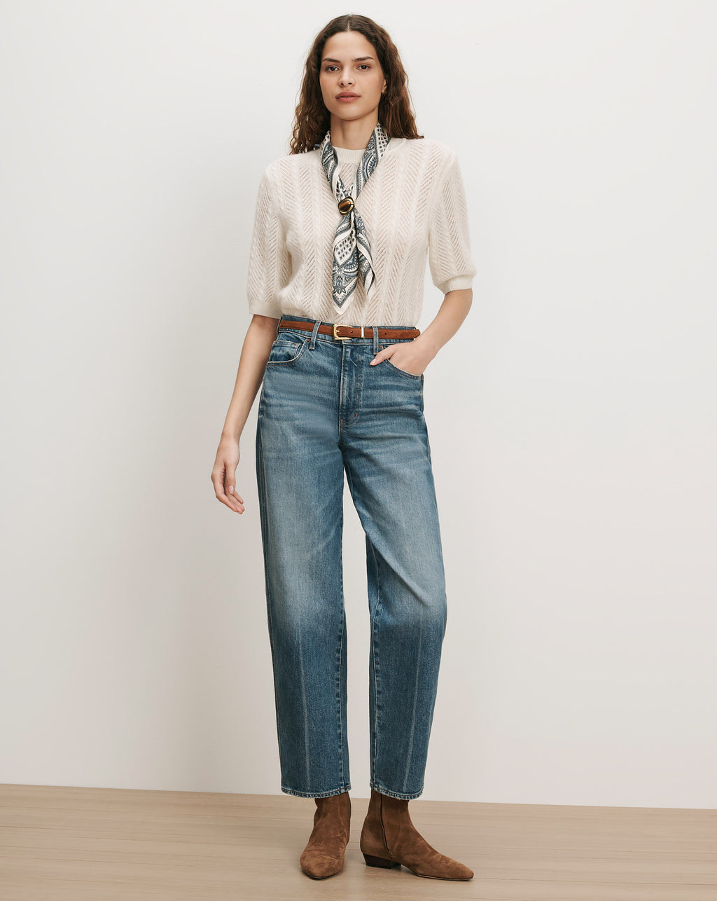 Veronica Beard Cream knit short-sleeve sweater, blue jeans, brown belt, silk scarf