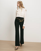 Veronica Beard White silk pussy-bow blouse and black flared trousers.