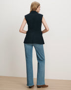 Veronica Beard Navy sleeveless blazer, wide-leg jeans.