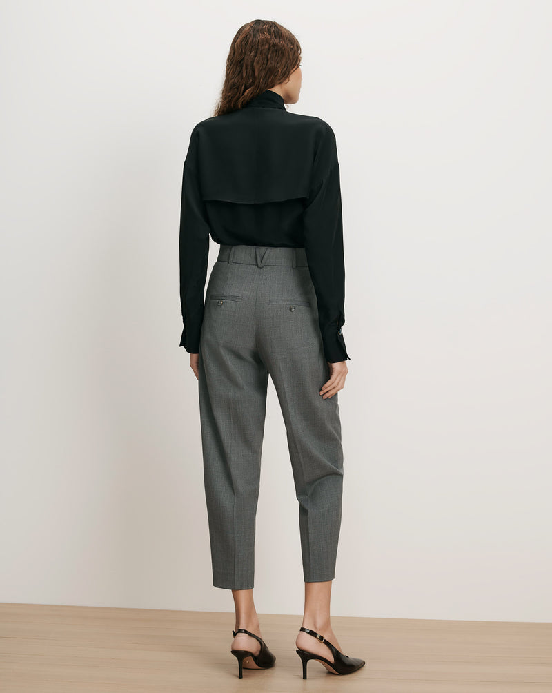 Veronica Beard Black silk blouse, gray wool trousers.