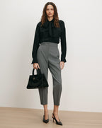 Veronica Beard Black silk blouse, gray trousers, black heels, black handbag.