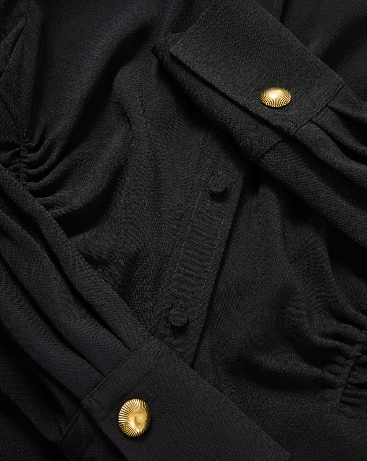 Veronica Beard Black blouse with gold buttons.