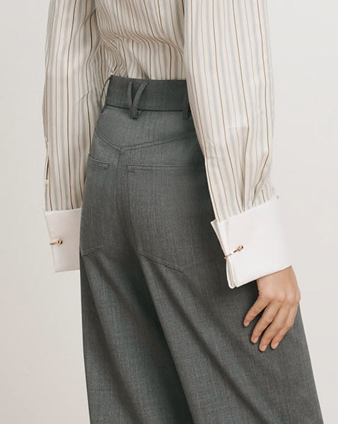 Veronica Beard Gray wide-leg trousers and striped button-up shirt.