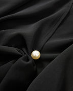 Veronica Beard Black blouse with a pearl button.