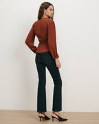Veronica Beard Rust long-sleeve blouse with cinched waist.
