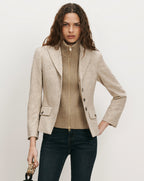 Veronica Beard Beige tweed blazer, ribbed turtleneck, dark wash jeans.