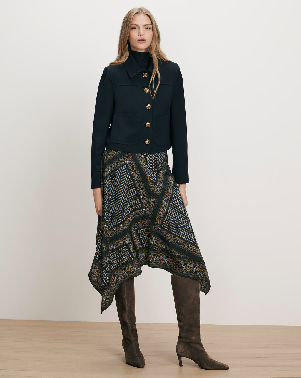 Veronica Beard Navy jacket, patterned skirt, brown boots.