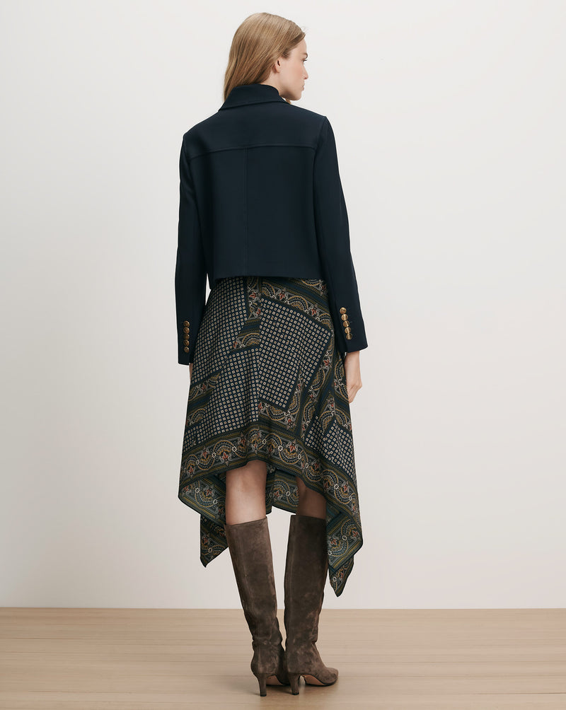 Veronica Beard Navy cropped jacket, paisley handkerchief hem skirt, brown boots.
