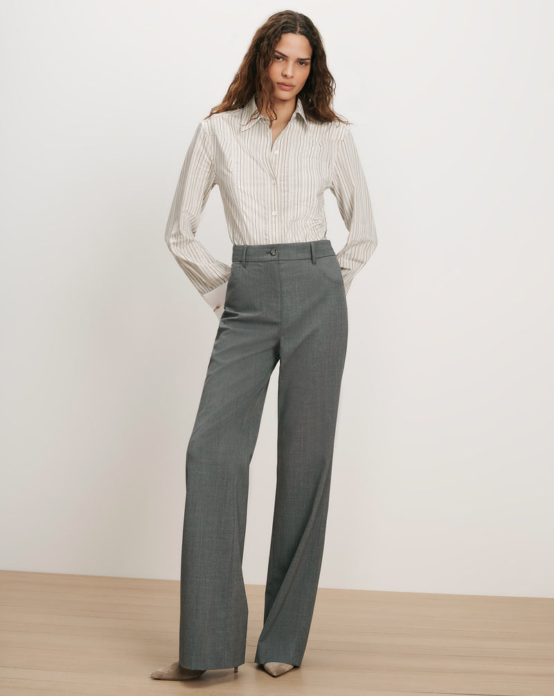 Veronica Beard Striped button-up shirt and gray wide-leg trousers.