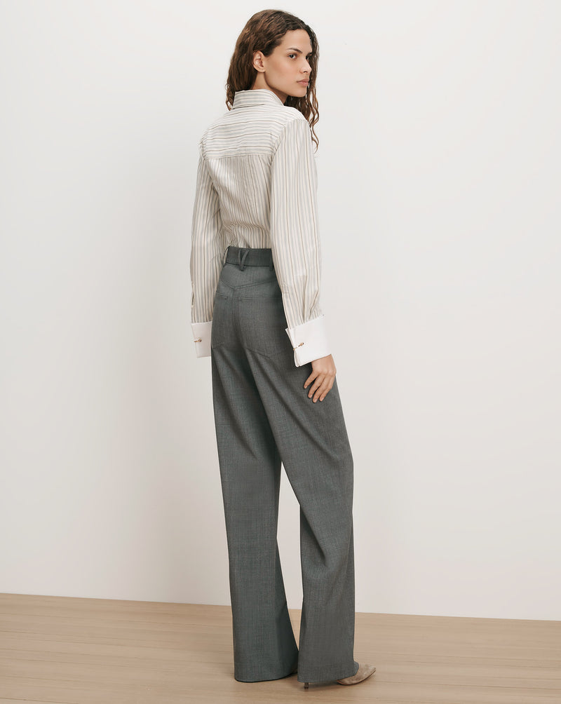 Veronica Beard Striped button-up shirt, gray wide-leg trousers.