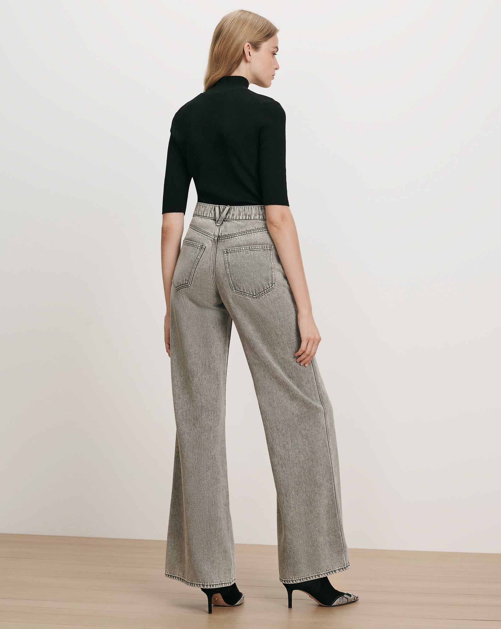 Veronica Beard Black ribbed turtleneck top, gray wide-leg jeans