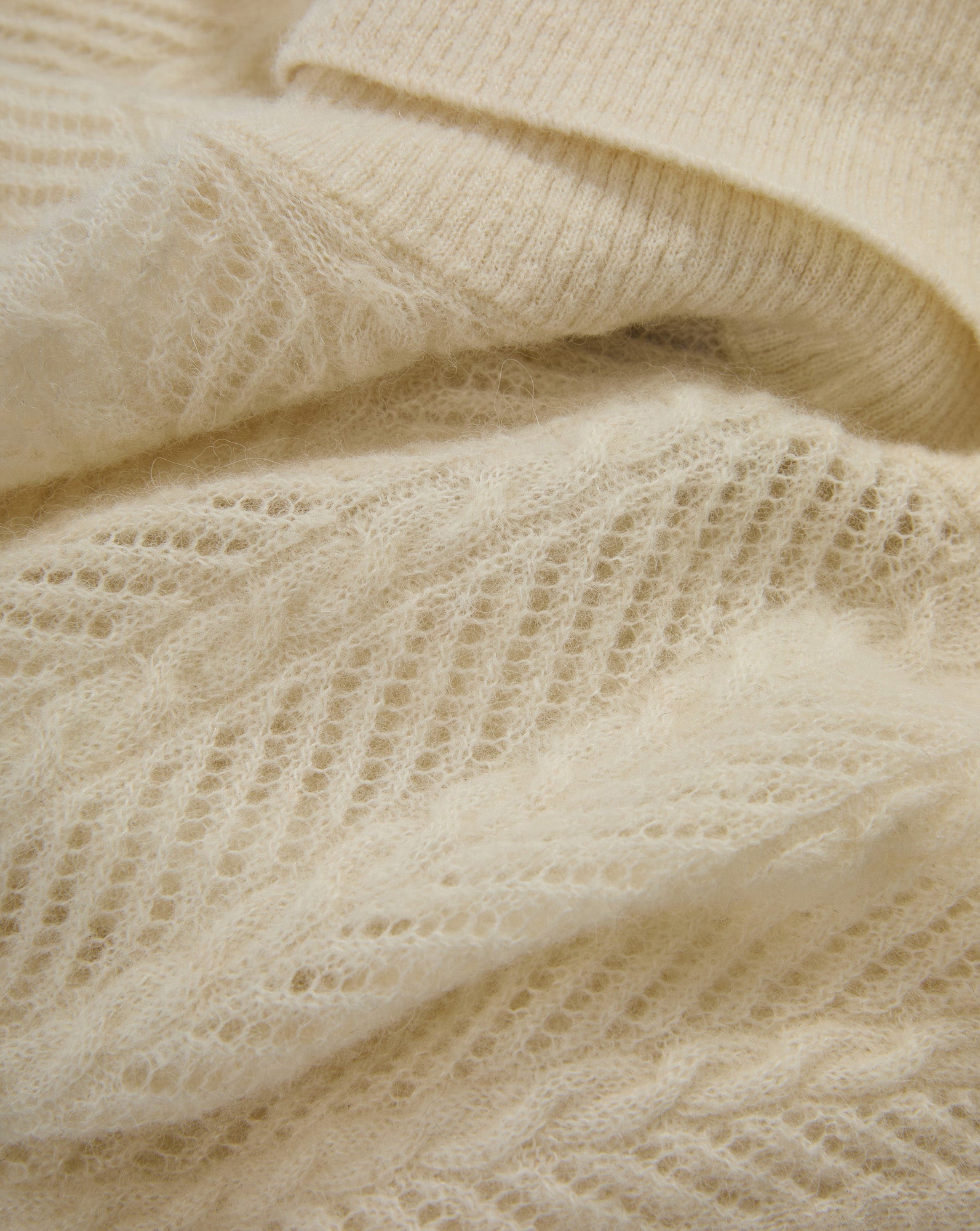 Veronica Beard Cream mohair sweater with open-knit pattern.