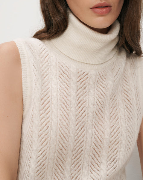 Veronica Beard Cream sleeveless turtleneck sweater with cable knit pattern.