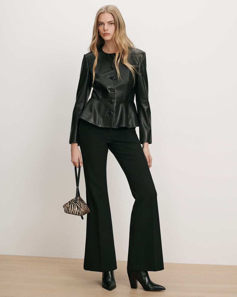 Veronica Beard Black leather peplum jacket, black trousers.