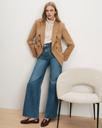Veronica Beard Camel blazer, cream turtleneck, blue jeans, brown loafers.