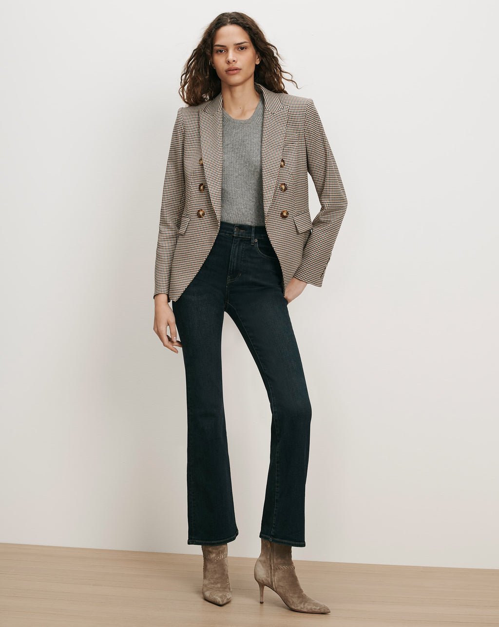 Veronica Beard Brown plaid double-breasted blazer, gray sweater, dark wash jeans.