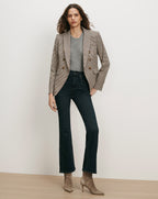 Veronica Beard Brown plaid double-breasted blazer, gray sweater, dark wash jeans.