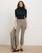 Veronica Beard Black ribbed turtleneck, brown plaid pants, brown loafers.
